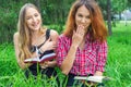 Two teenage girls reading books in park Royalty Free Stock Photo