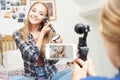 Two Teenage Girls Recording Beauty Blog In Bedroom