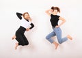 Two teenage girls smiling and jumping friends Royalty Free Stock Photo