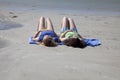 Two Teenage Girls Sunbathing at the Beach Royalty Free Stock Photo