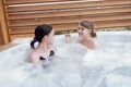 Two teenage girls in swimsuits spending time in the jacuzzi Royalty Free Stock Photo