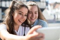 Two Teenage Girls Taking Selfie On Mobile Phone Outdoors Royalty Free Stock Photo