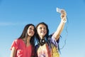 Two Teenage Girls Taking Selfie In Park