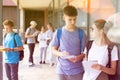 Two teenage students discussing near college building Royalty Free Stock Photo