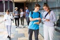 Two teenage students discussing near college building Royalty Free Stock Photo