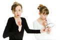 Two teenaged girls haggle to get a mirror to make a make up - sister rivalry Royalty Free Stock Photo