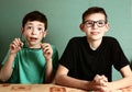 Two teenager boys in myopia glasses close up