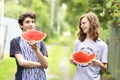Teenager boys with water melon slice eating smile on the green country background Royalty Free Stock Photo
