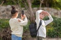 Young girls take a photo with smartphone outdoor.