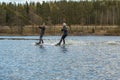 Two teenager wakeboarding on a lake in Sweden