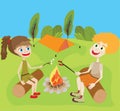 Two teenagers at campfire sitting on logs on a green field