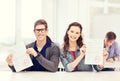 Two teenagers holding test or exam with grade A