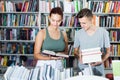 Two teenagers reading book in book store Royalty Free Stock Photo