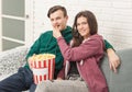 Two teenagers are sitting on the couch watching TV Royalty Free Stock Photo