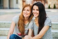 Two teenagers sitting on the stairs and listening music Royalty Free Stock Photo