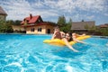 Two teenagers swimming in the pool Royalty Free Stock Photo