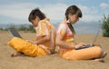 Two teens with laptops Royalty Free Stock Photo