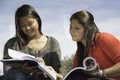 Two teens or young women studying