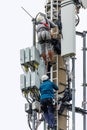 Telekom technicians perform work on a transmission tower