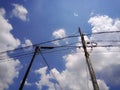 two telephone and electricity poles adjacent to messy wires Royalty Free Stock Photo