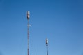 Two telephone towers against a clear blue sky Royalty Free Stock Photo