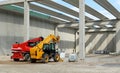 Two telescopic handlers inside a concrete block building under construction. Royalty Free Stock Photo