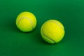 Two tennis balls on a green background Royalty Free Stock Photo