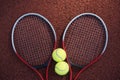 Two tennis balls and two racquets on tennis court Royalty Free Stock Photo