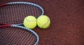 Two tennis balls and two racquets on tennis court Royalty Free Stock Photo