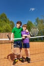 Two tennis winners standing next to the net Royalty Free Stock Photo