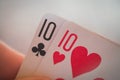 Two tens, Playing cards in hand on the table, poker nands