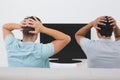 Two tensed soccer fans watching tv Royalty Free Stock Photo