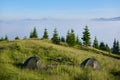 Two tents in the hikers camp in the mountains in sunny morning facing incredible rising fog from a valley Royalty Free Stock Photo