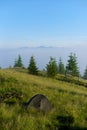 Two tents in the hikers camp in the mountains in sunny morning facing incredible rising fog from a valley Royalty Free Stock Photo