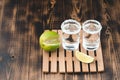 Two Tequila shots with lime slices and salt on wooden table/Tequila shots and lime slice on wooden table with Copy cpace. Top view