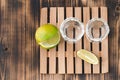 Two Tequila shots with lime slices and salt on wooden table/Tequila shots and lime slice on wooden table with Copy cpace. Top view Royalty Free Stock Photo