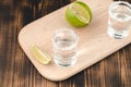 Two Tequila shots with lime slices and salt on wooden table/Tequila shots and lime slice on wooden table. Top view. Royalty Free Stock Photo