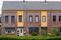 Two terraced houses decorated with diverse plants, modern dutch architecture, village homes in the Netherlands