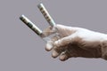 Two test tubes with hundred dollar bills in the hand of a medic or laboratory assistant. White glove. Concept medicine and money, Royalty Free Stock Photo