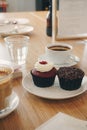 Two testy cupcakes with the coffee cups in the cafe Royalty Free Stock Photo