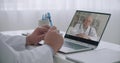 Two therapists are consulting online to each other by videoconference from their offices in clinics, elderly doctor on