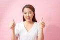 Two thumbs up hand sign from beautiful women on pink background Royalty Free Stock Photo