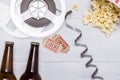 Two tickets, beer and popcorn for going to the cinema, background Royalty Free Stock Photo