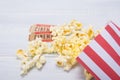 two tickets to the cinema, along with a package of scattered popcorn, on a light, white background Royalty Free Stock Photo