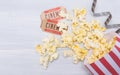 Two tickets to the cinema, film and scattered popcorn, on a gray background, with a place for the inscription Royalty Free Stock Photo