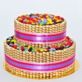 Two tier chocolate decorated with finetti sticks and colorful candy Royalty Free Stock Photo