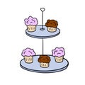 Two-tier serving tray with cupcakes. Plate with sweet dessert