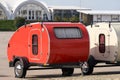 Two tiny red and white campers are available for rent on site. Selective focus Royalty Free Stock Photo
