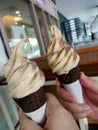 Two tiramisu ice cream sundae. Black cone. Chocolate cone