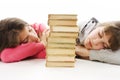 Two tired teenage girls with pile book Royalty Free Stock Photo